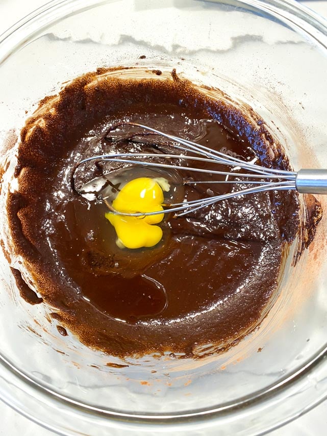 whisking eggs into brownie batter