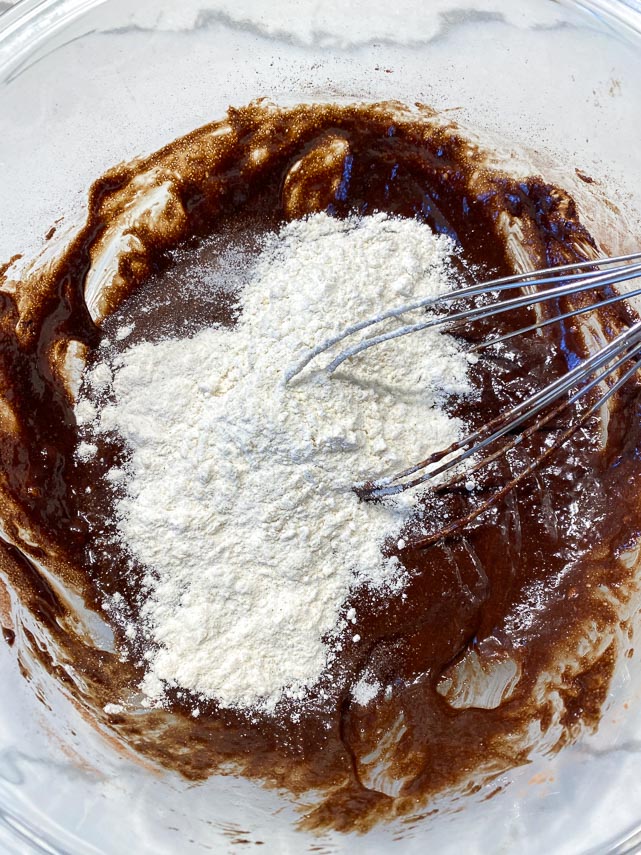 whisking flour into brownie batter