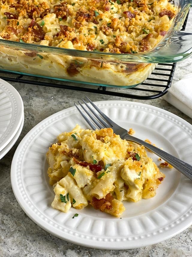 Low FODMAP Chicken & Bacon Ranch Mac and Cheese in glass dish, also plated on white plate with fork