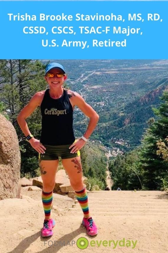 A photo of a female athlete in shorts and rainbow socks standing atop a mountain with her hands on her hips. This is her story about dealing with IBS in the military. 