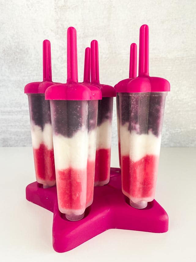 vegan red, white and blue low FODMAP pops frozen in their popsicle mold