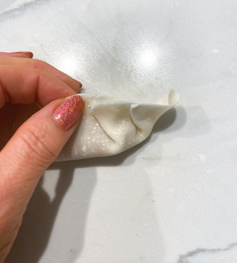 creating pleats in dumpling skin