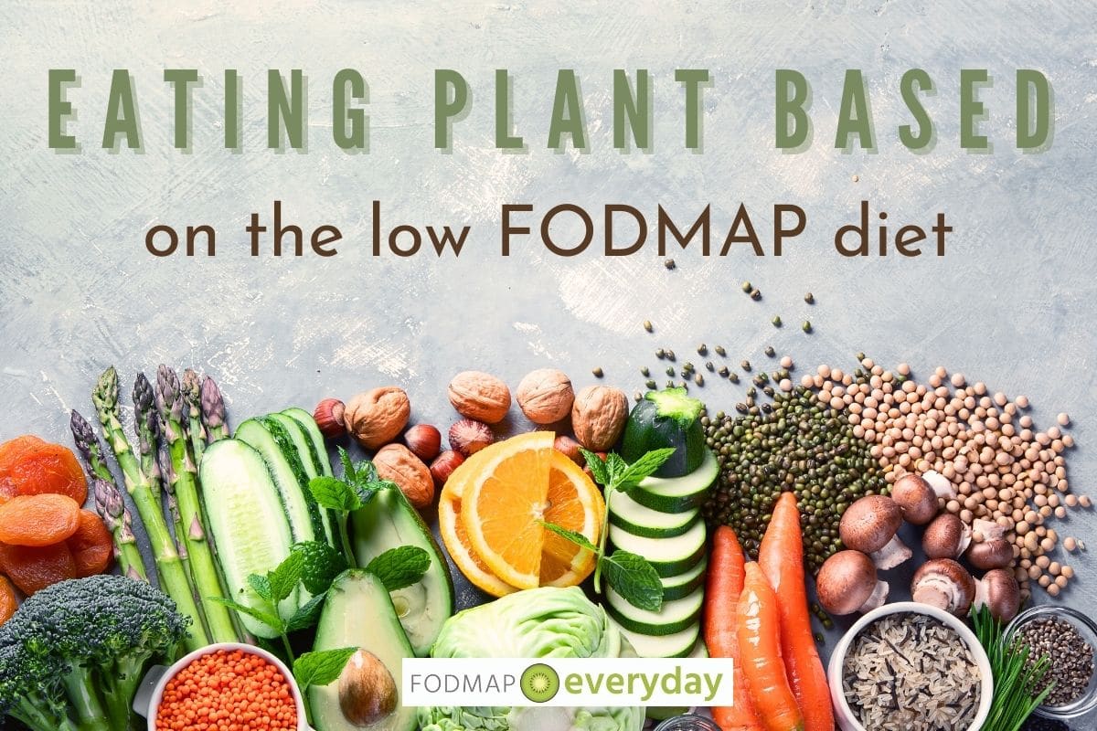 an overhead view of fruits and vegetables and grains upon a marbled background with the words Eating Plant Based on the Low FODMAP Diet across the top.