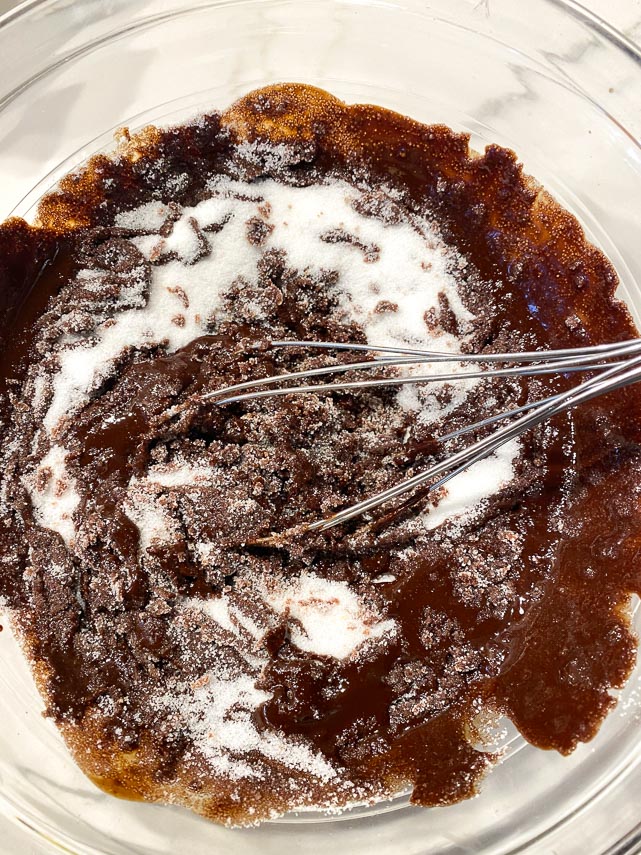 making brownie batter in glass bowl with whisk