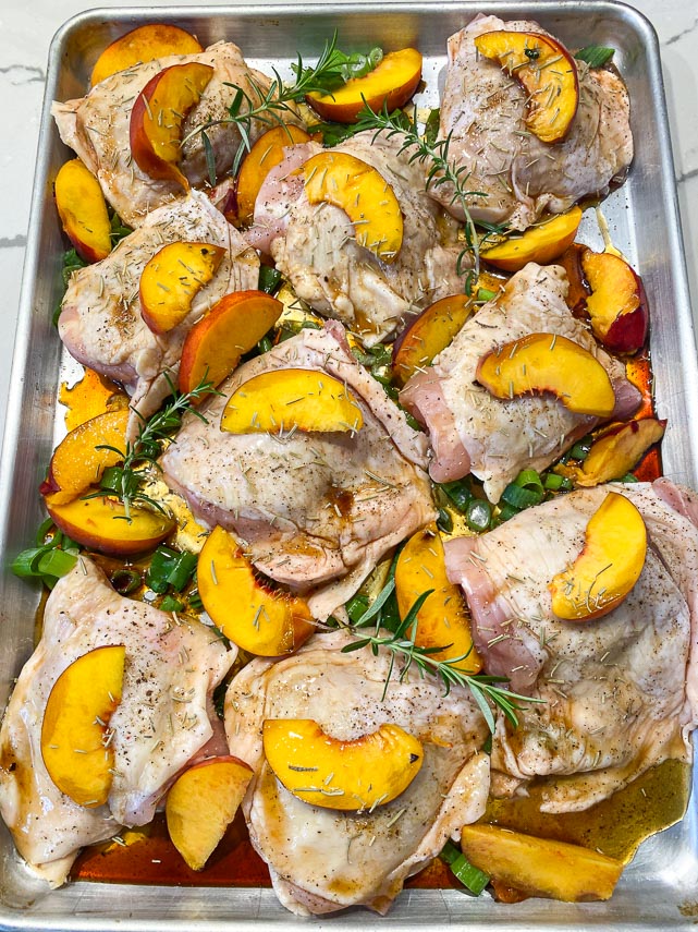 Chicken thighs with peaches and rosemary on a sheet pan