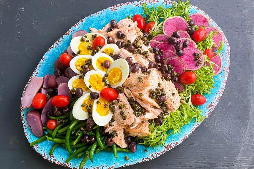 Low FODMAP Salmon Salade Nicoise on oval turquoise platter