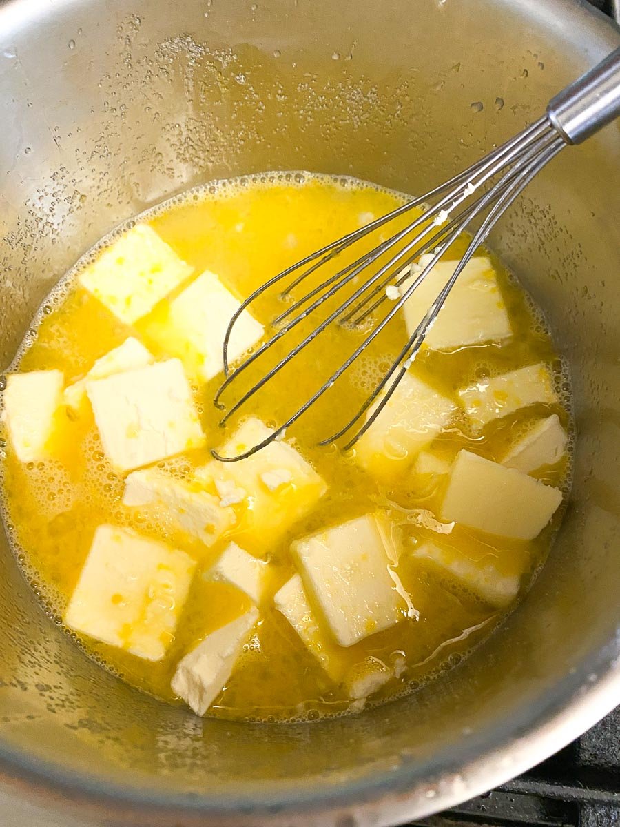 butter added to lime curd ingredients in pot