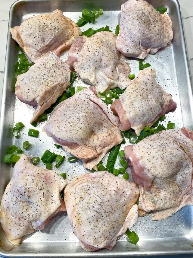 chicken and scallion on sheet pan, seasoned with salt and pepper