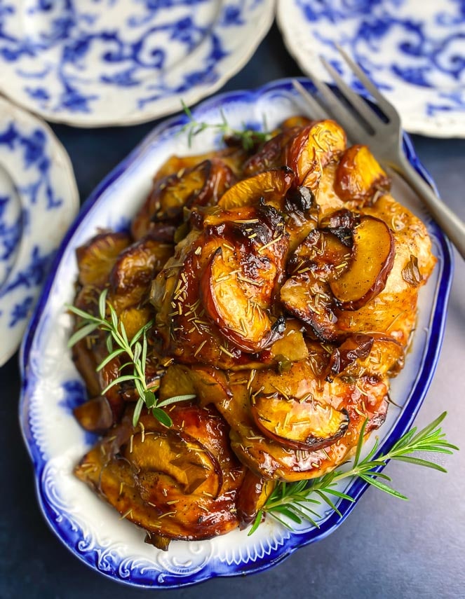closeup of low FODMAP Balsamic Chicken with peaches on blue and white platter