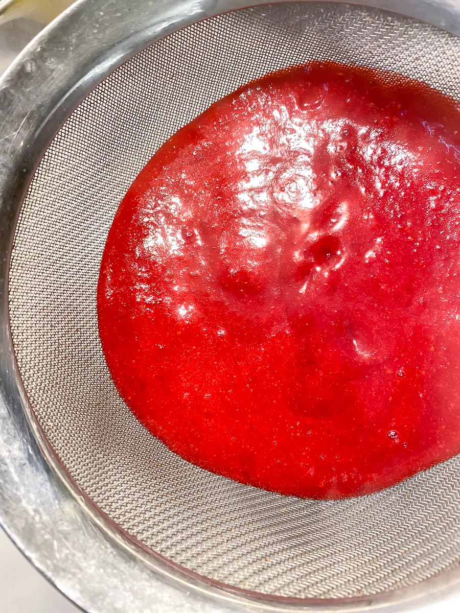 cranberry purée in strainer over bowl