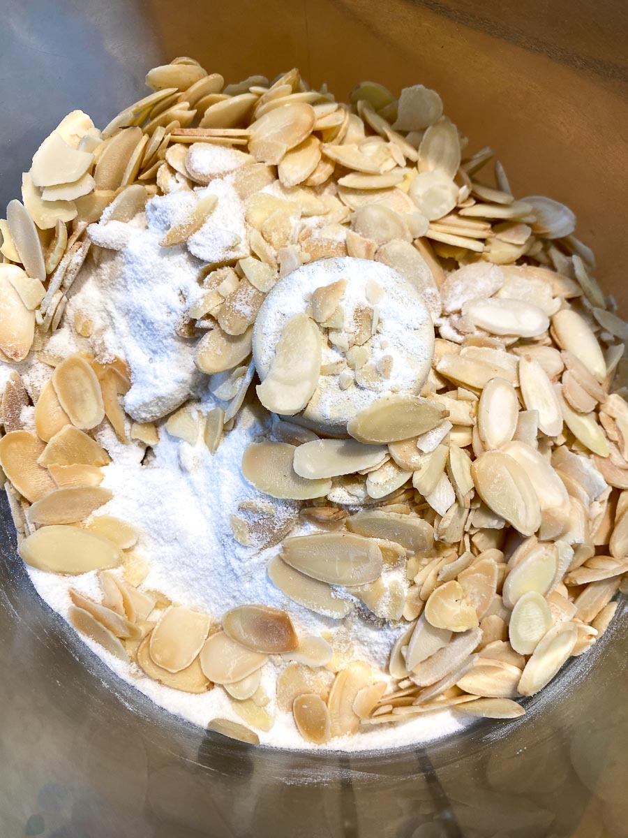 flour and sliced blanched almonds in food processor bowl