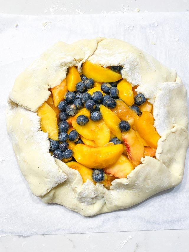 making a fruit crostata or galette, on parchment paper
