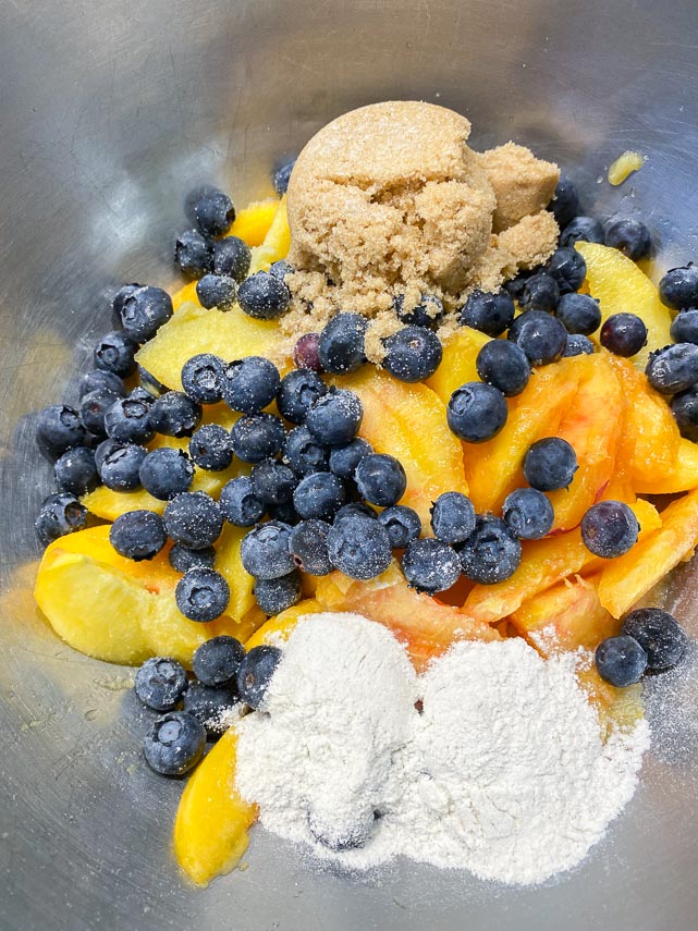 peach blueberry crostata filling ingredients in bowl
