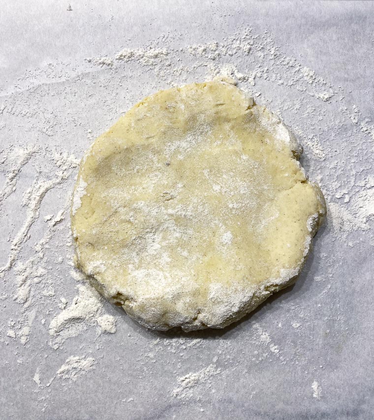 tart dough disc on floured parchment paper