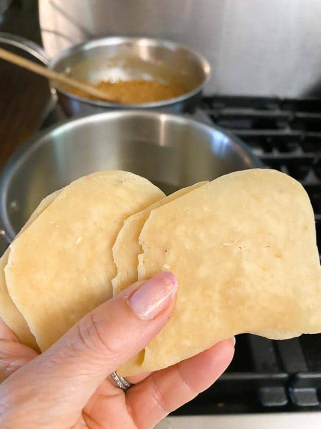 uncooked shrimp crackers held in hand to show size