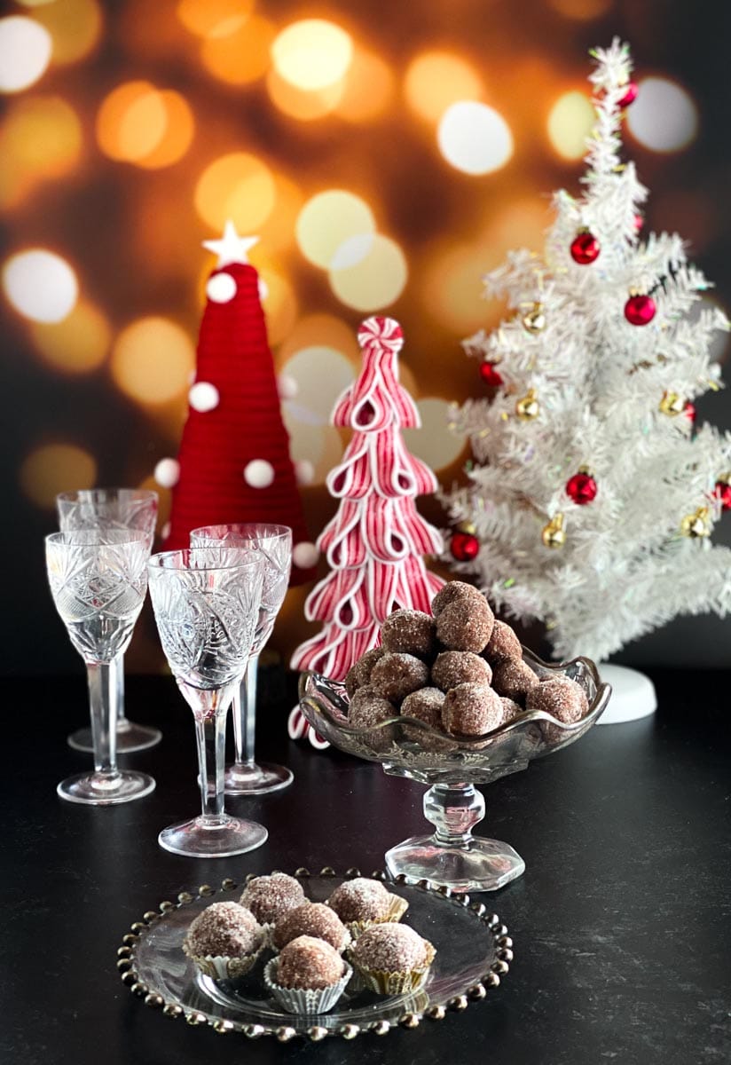 Low FODMAP Chocolate Whiskey Balls in decorative glass dishes against Christmas table decor_