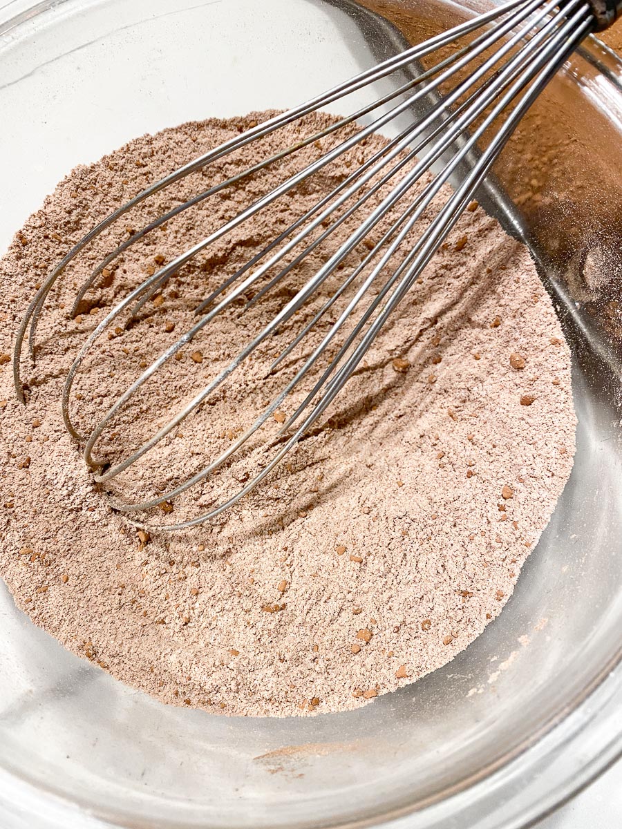 dry ingredients whisked together in glass bowl for cocoa cake