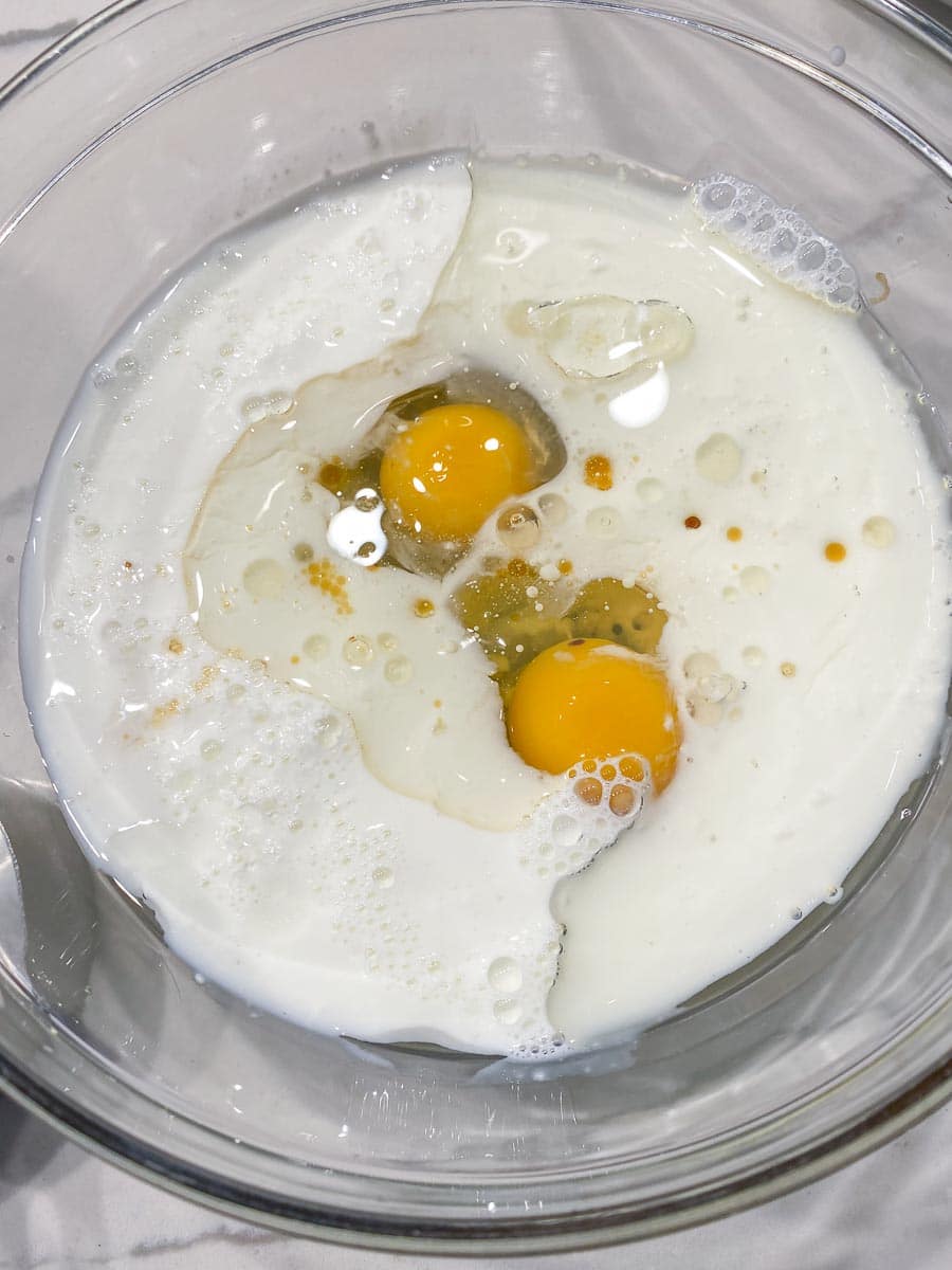 eggs and buttermilk in glass bowl