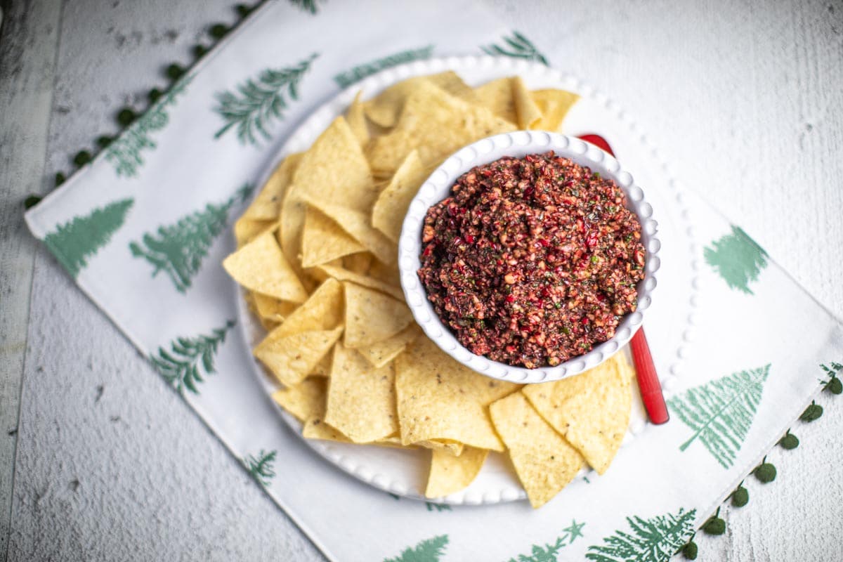 overhead image low FODMAP Cranberry Salsa in white bowl with chips