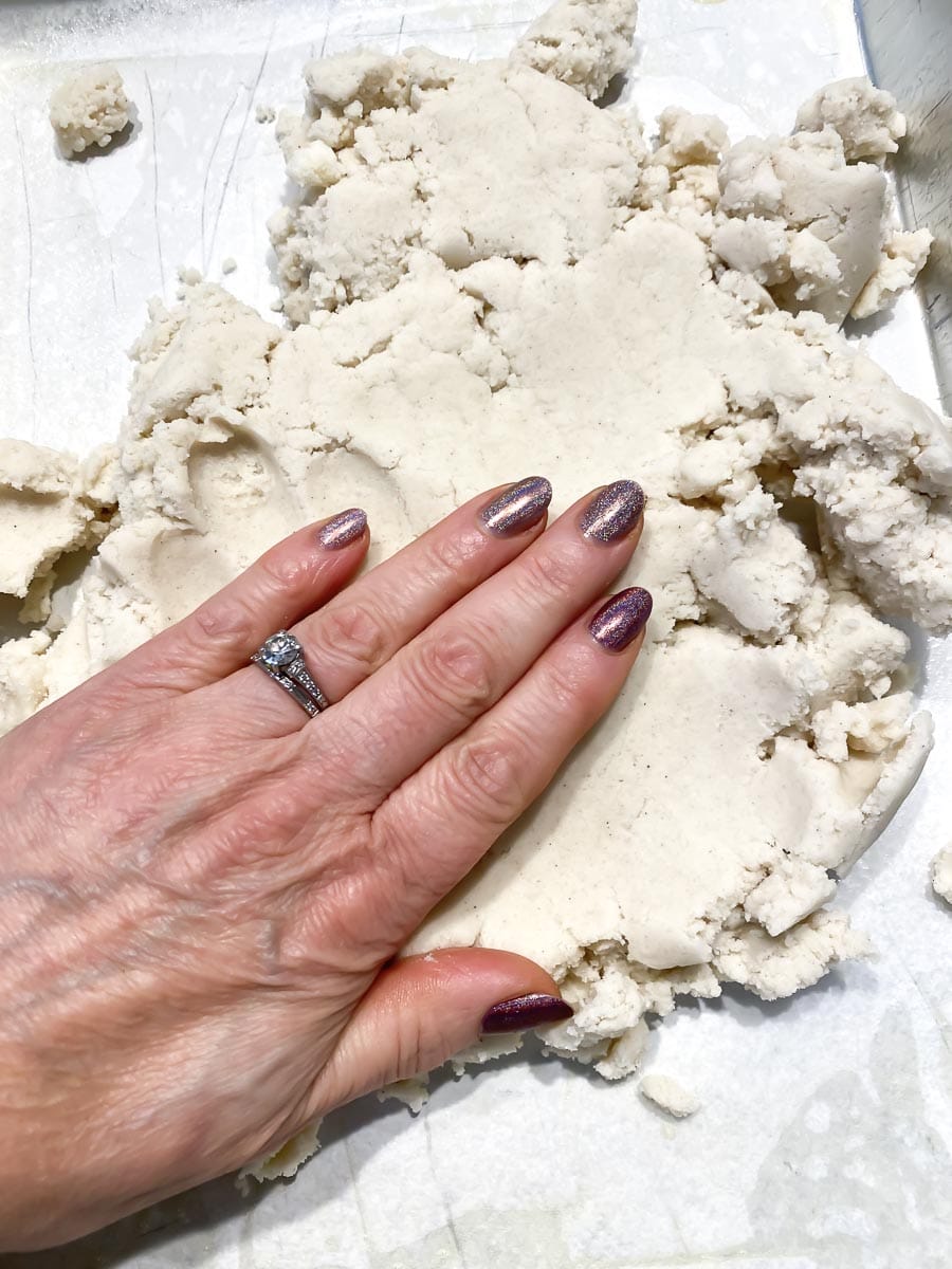 patting shortbread dough into pan