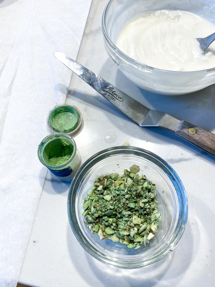 tossing chopped nuts with powdered green food coloring