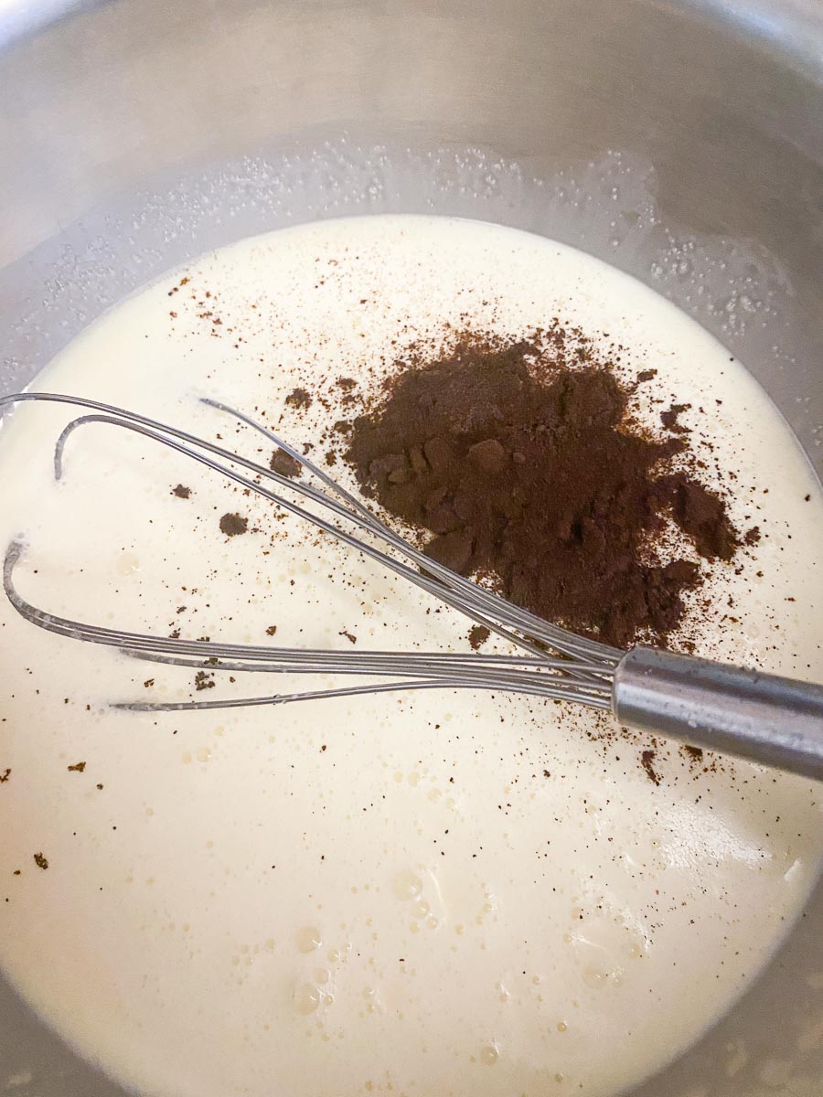 whisking cream, sugar and espresso powder together in saucepan