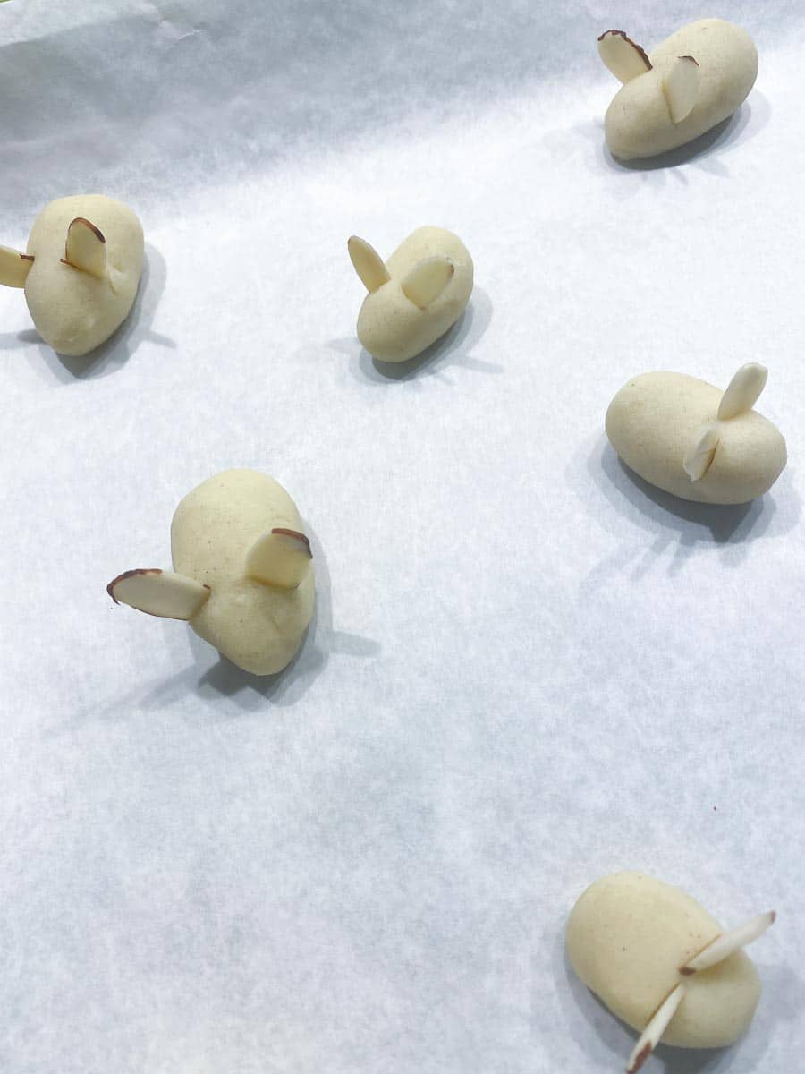 Forming sugar cookie dough into ovals, to create mice