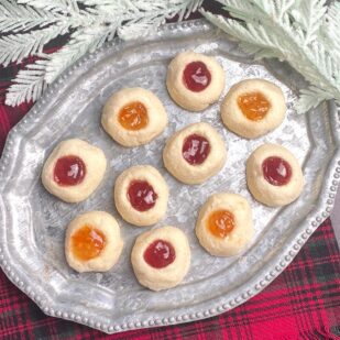 Low FODMAP Thumbprint Cookies on silver platter and red plaid napkin. Gluten-Free Christmas Cookies everyone will love
