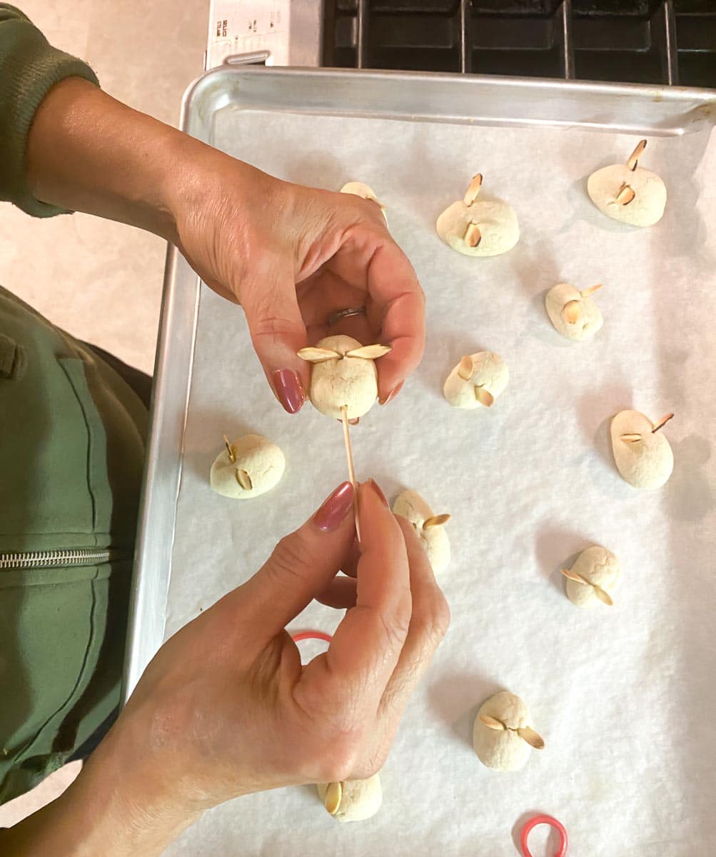 inserting bamboo skewers into cookie