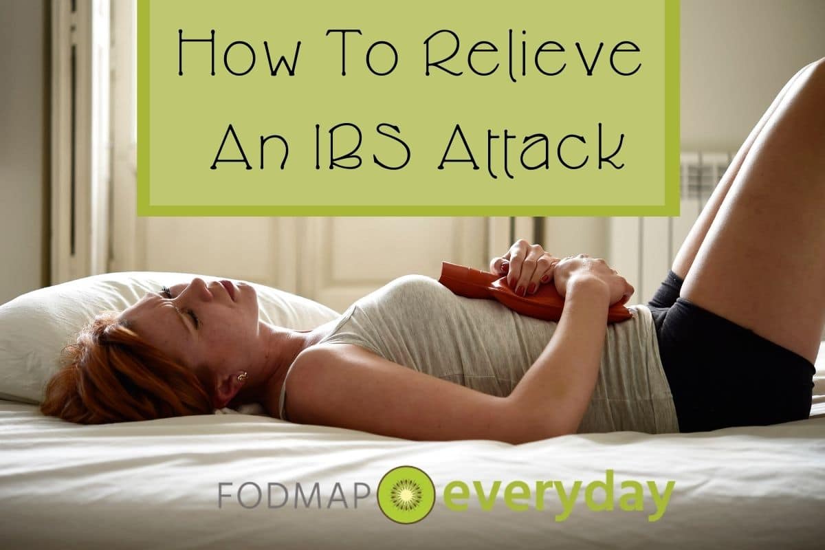 A young woman laying on her bed with a hot water bottle upon her stomach. Feature image for How To Relieve an IBS Attack. 