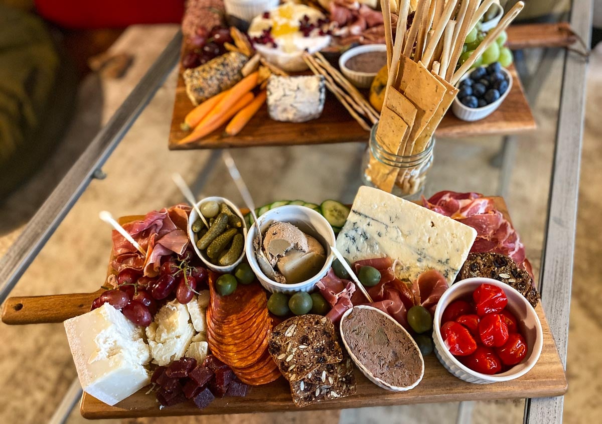 closeup Low FODMAP Charcuterie and Cheese board on coffee table