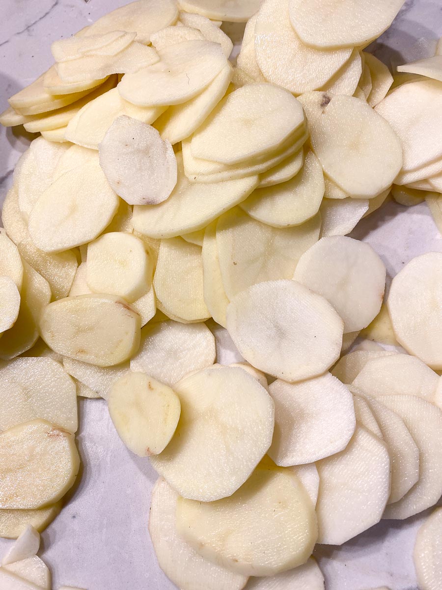 1/4-inch thick sliced potatoes on white surface