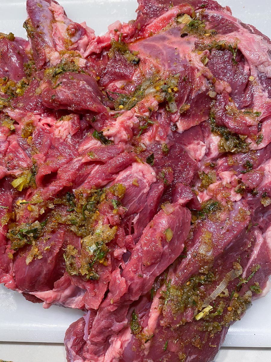 Butterflied leg of lamb spread with lemon and herbs
