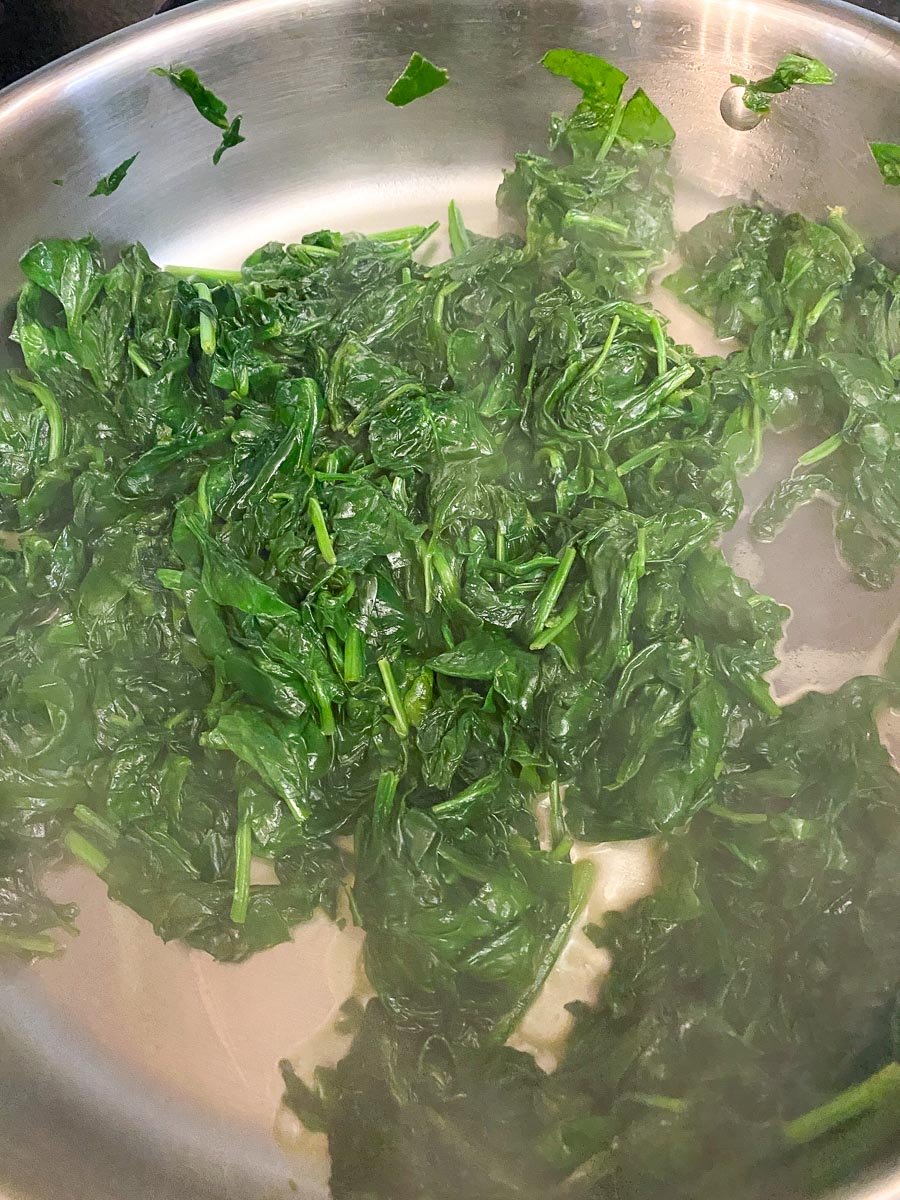spinach cooked down and wilted in pan