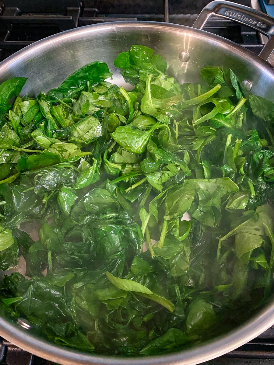 spinach cooking down in pan