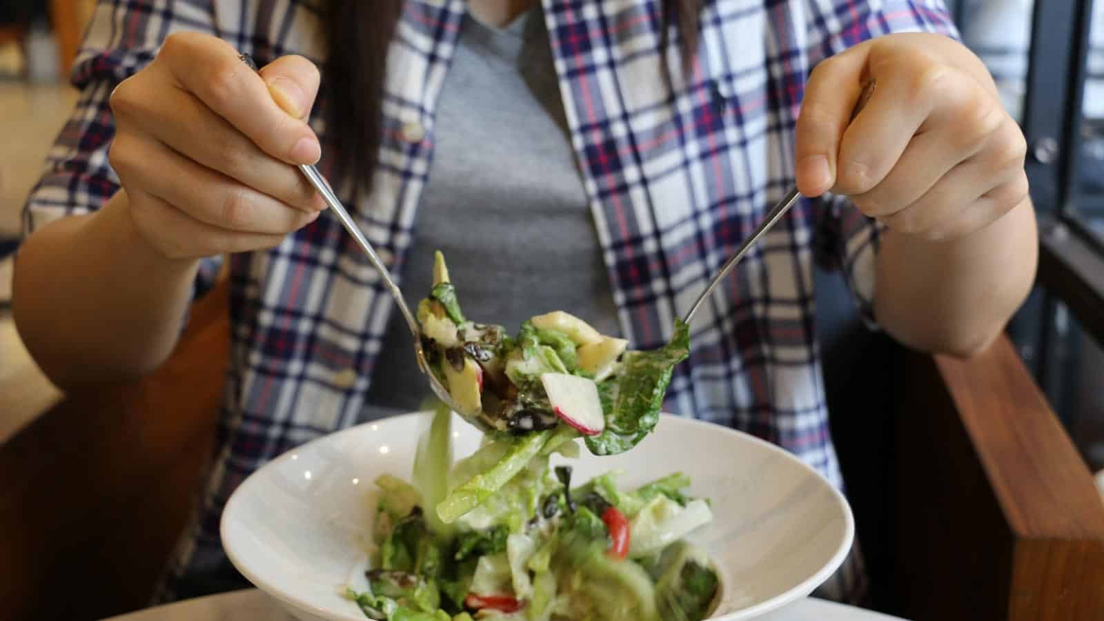 woman tossing salad. suranart via 123rf