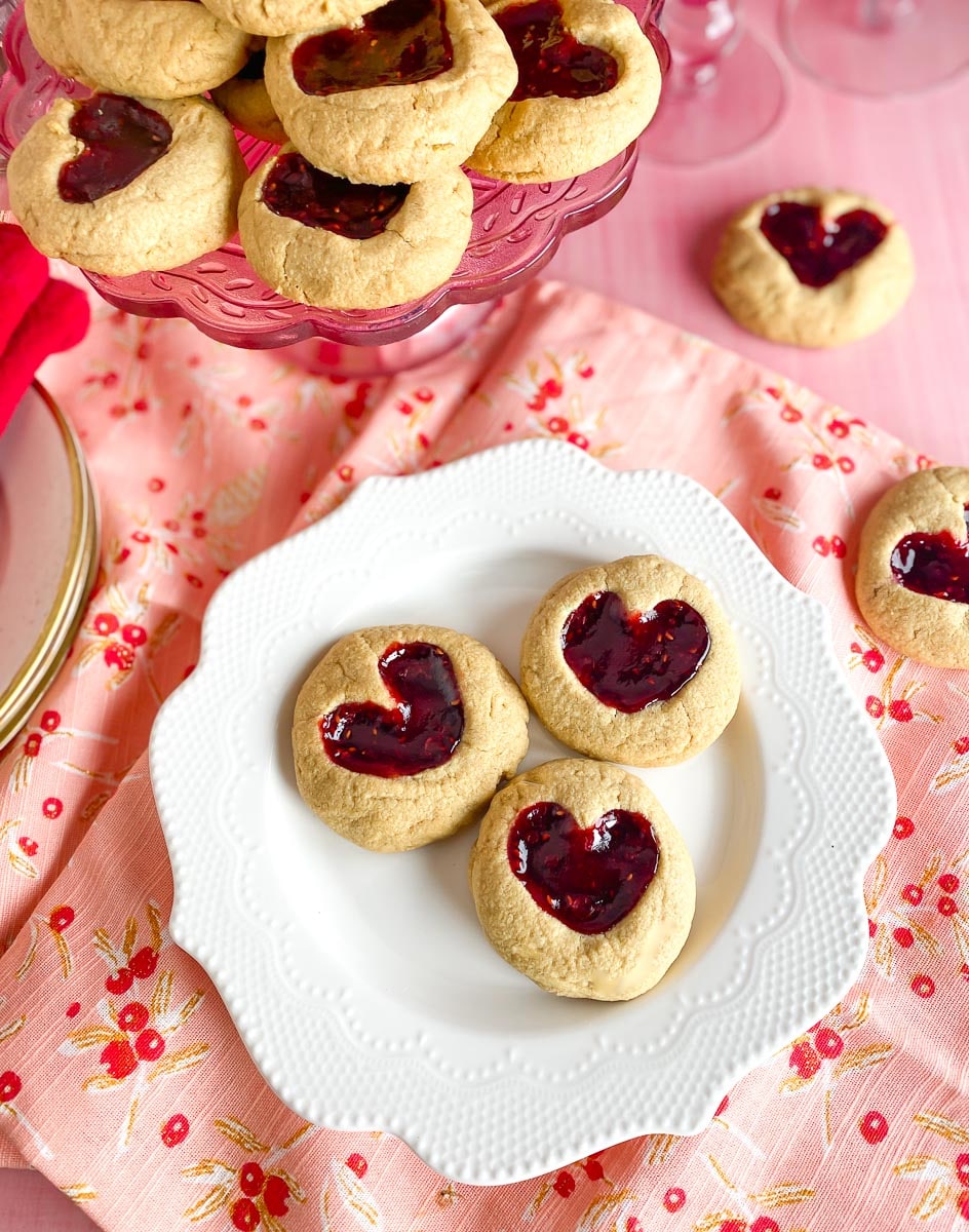 Low FODMAP Peanut BUtter & Jam Heart cookies on white plate and decorative napkin