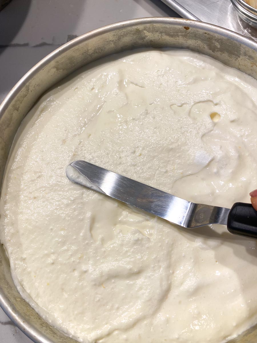 leveling cheese cake batter in pan with small offset spatula