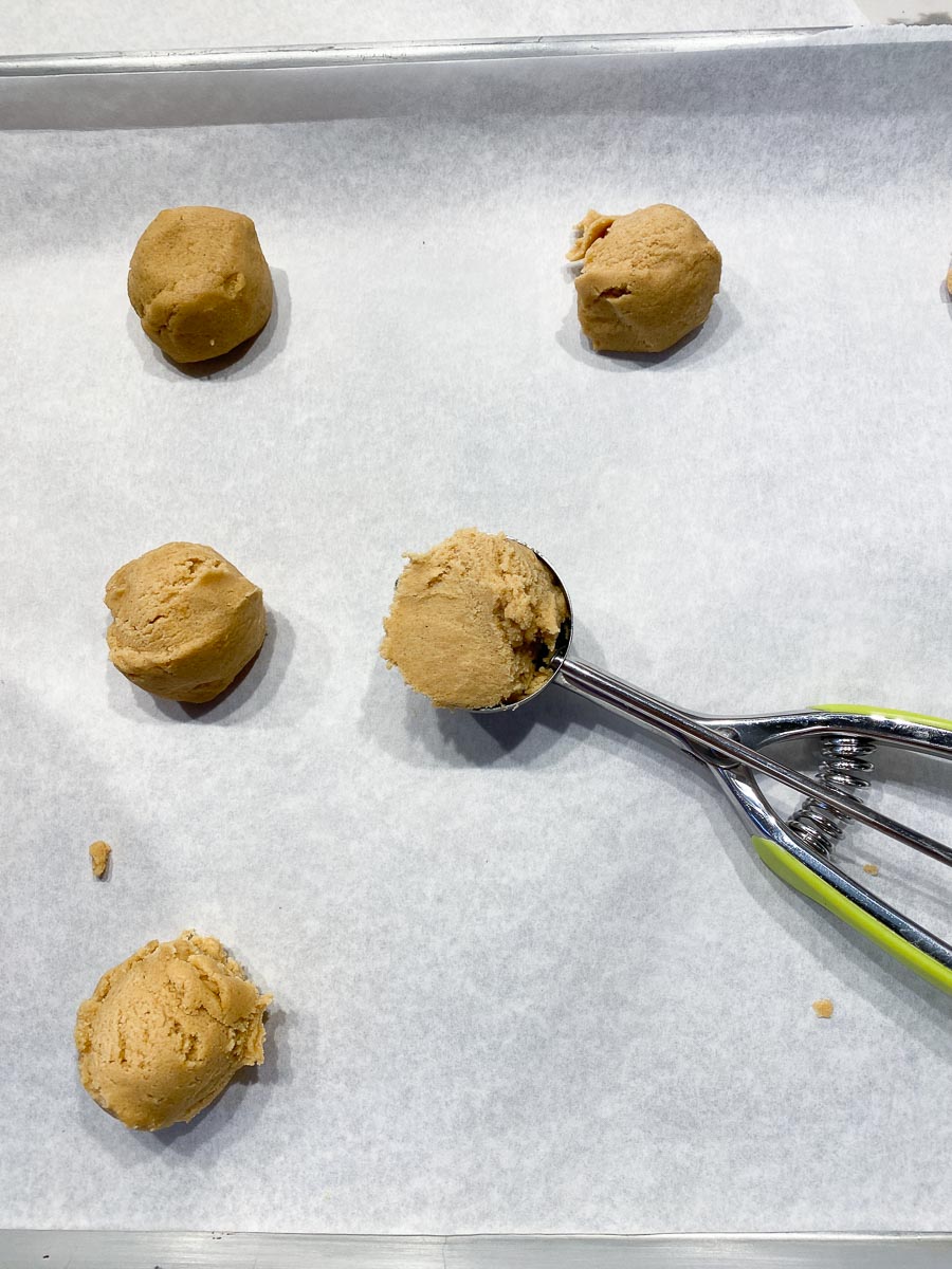 making peanut butter cookies using a scoop
