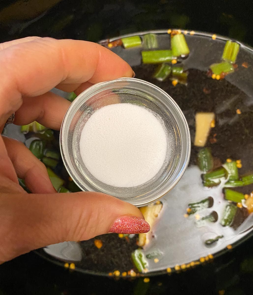 FreeFod garlic replacer in glass dish held in hand