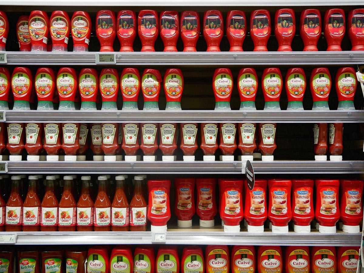 supermarket shelf of ketchup