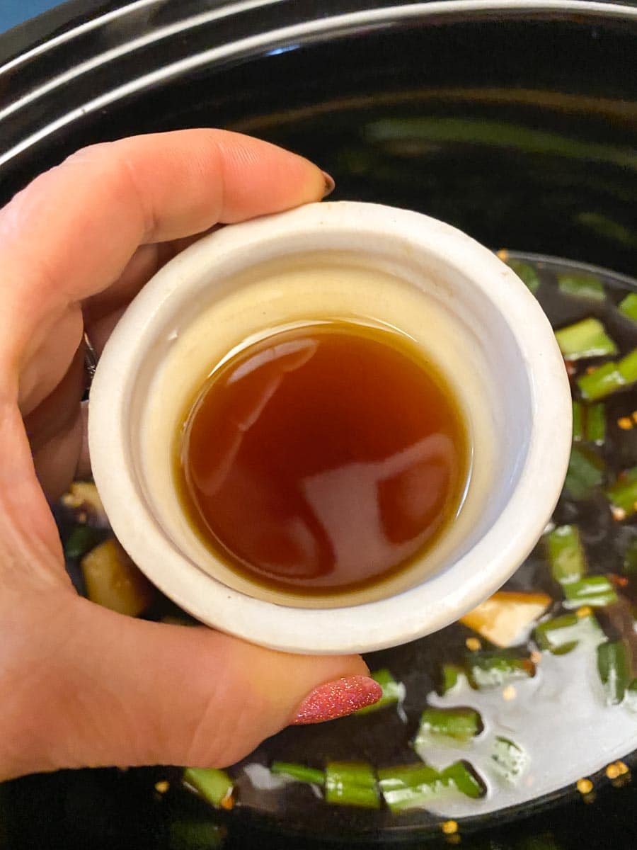 toasted sesame oil in white dish held in hand