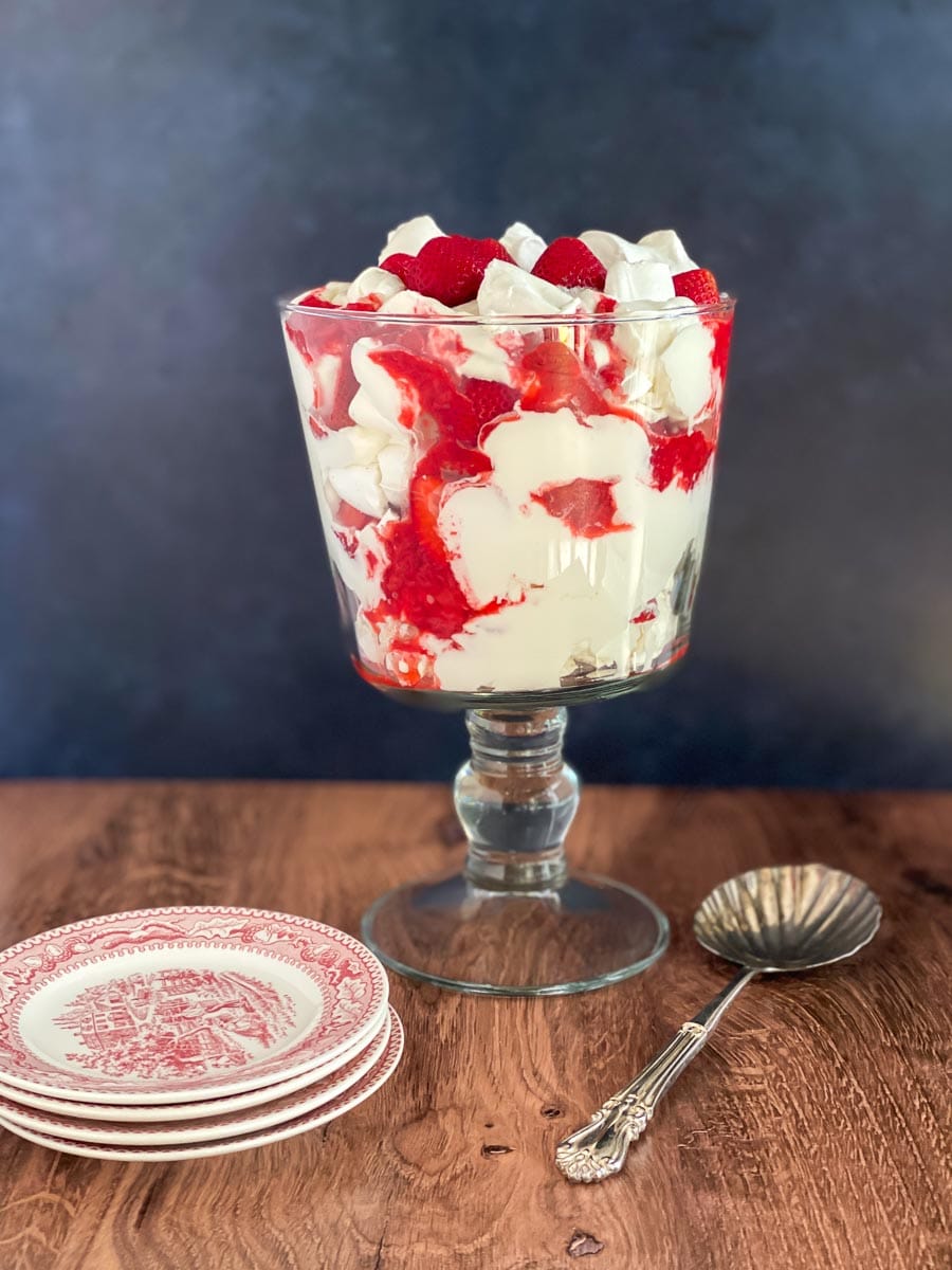 Low FODMAP Eton Mess in glass trifle bowl on wooden table