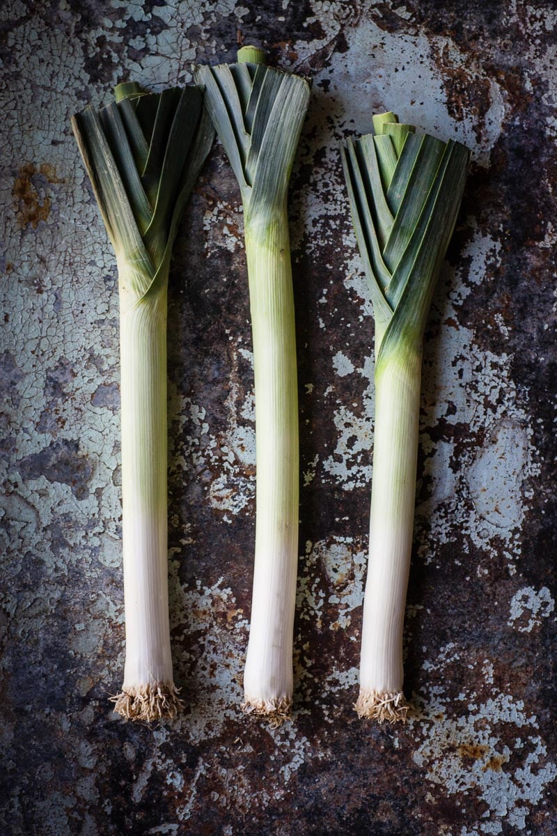 leeks on dark mottled background