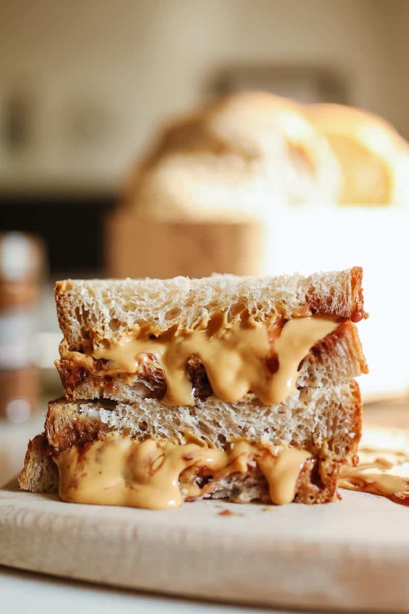 peanut butter sandwich on wheat bread on board