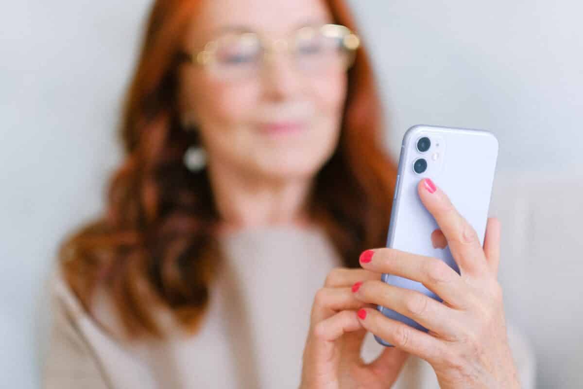 redheaded woman looking at smartphone