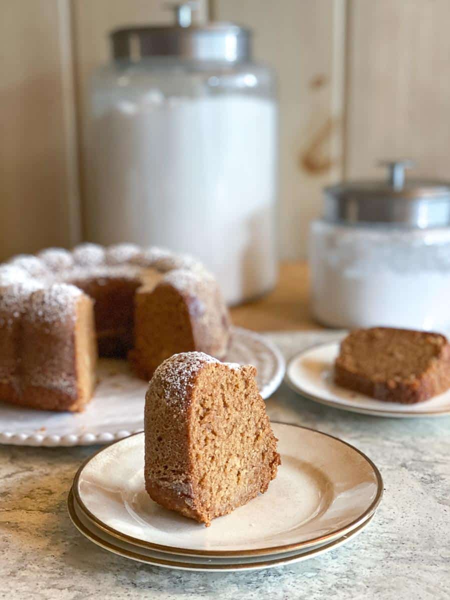 low FODMAP honey cake on white plate; whole cake in background