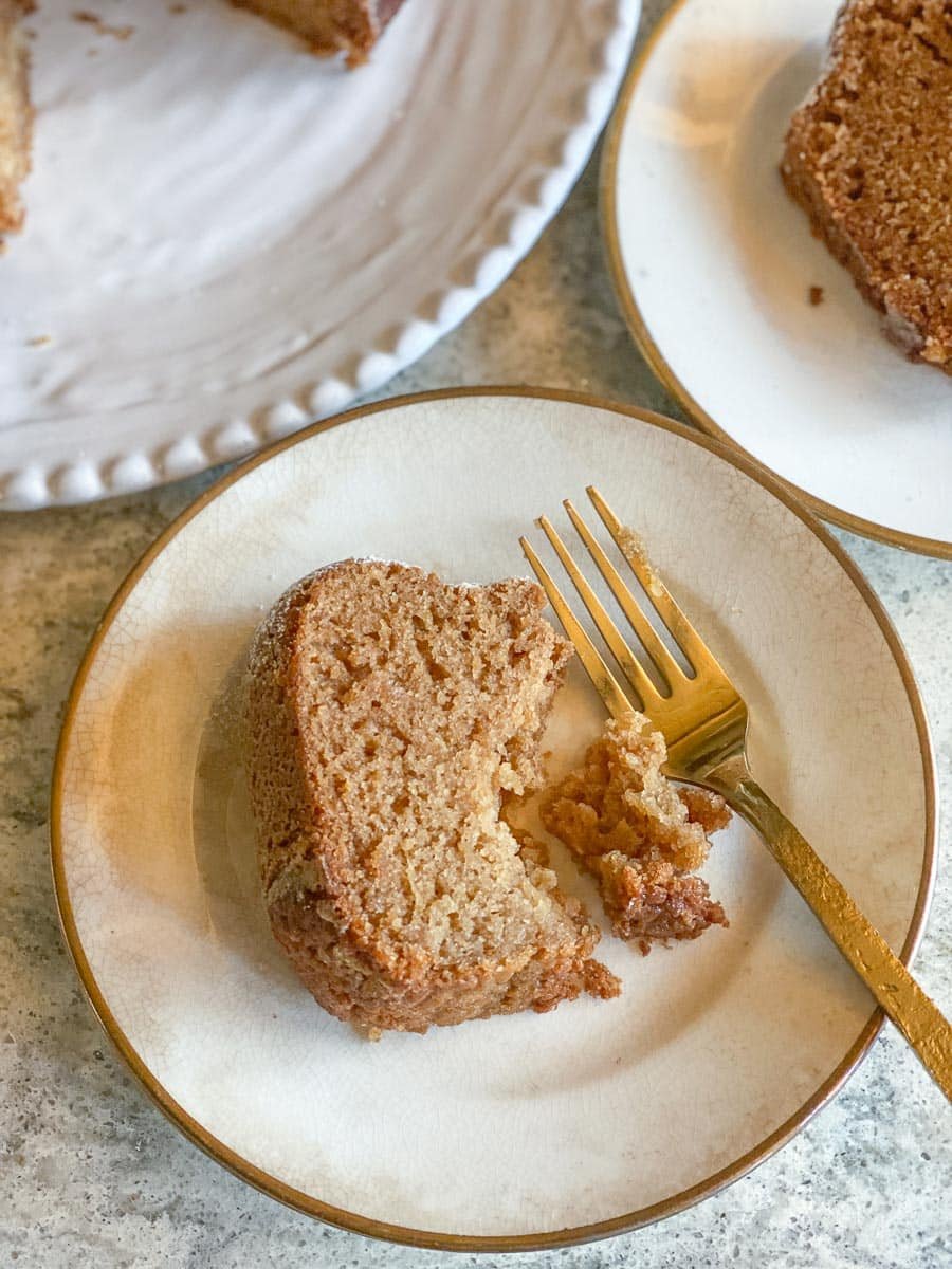 overhead of low FODMAP honey cake on white plate with gold fork