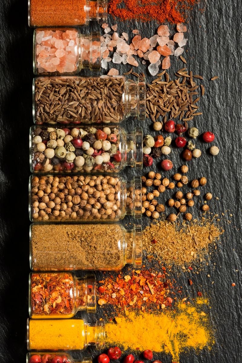 overhead of spices spilling from jars