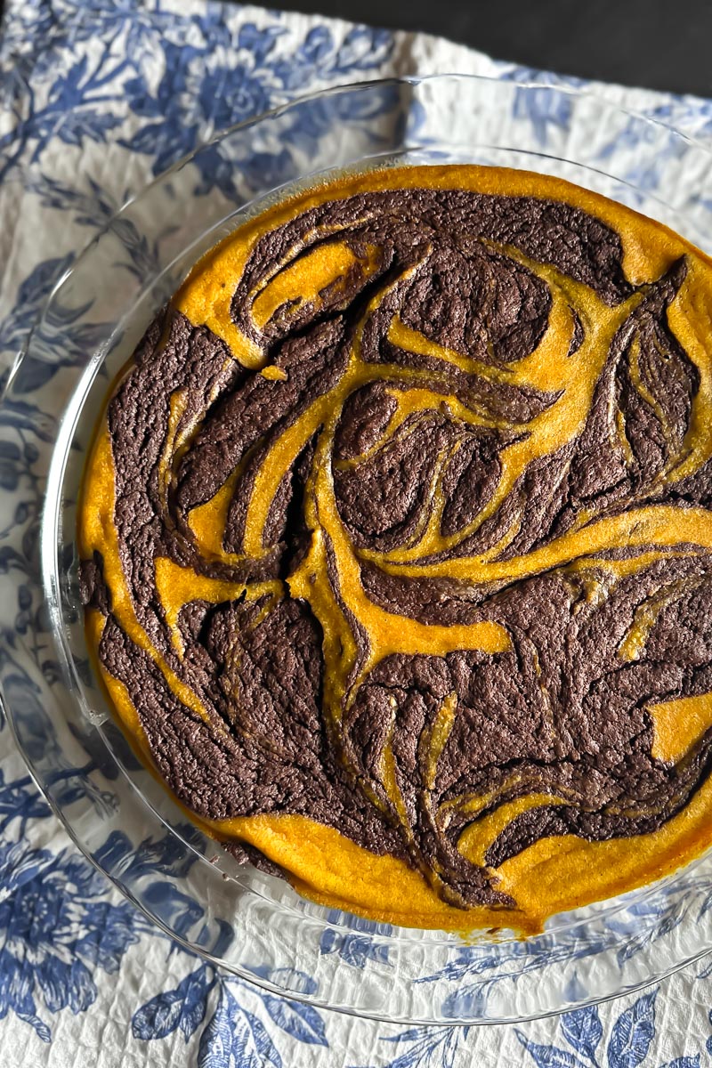 baked Low FODMAP Pumpkin Swirl Brownie Pie on blue and white cloth